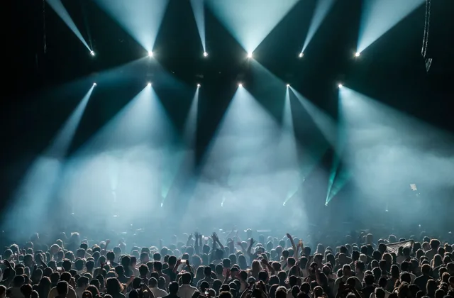 Stage lights over a concert crowd