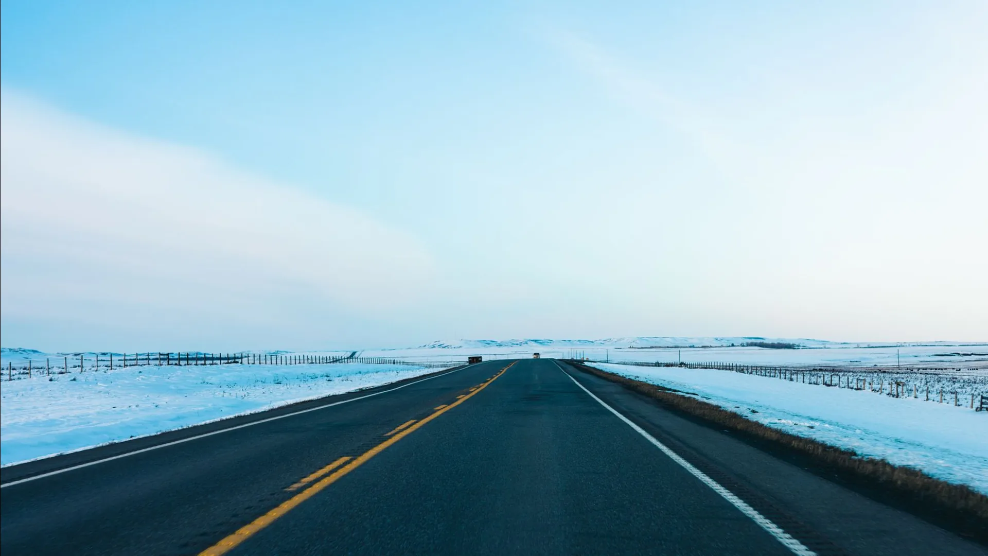 Open road toward the horizon under a big sky