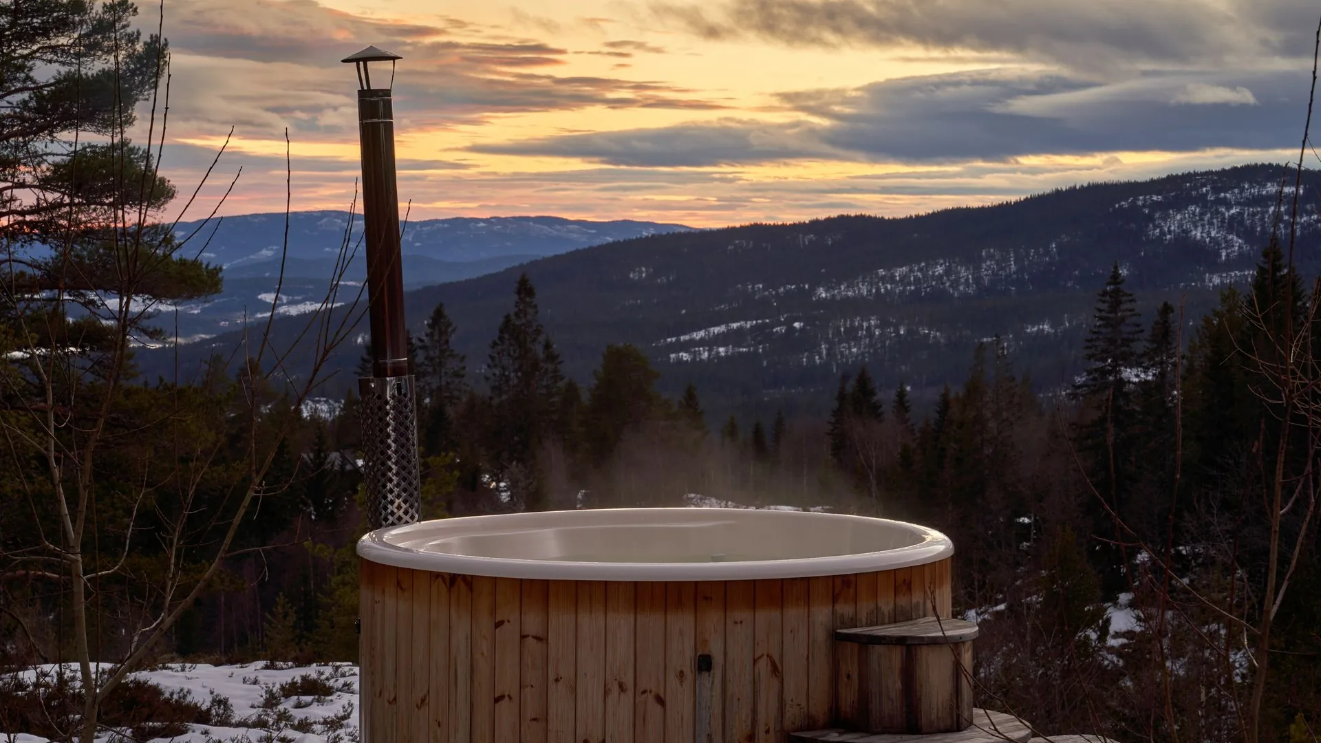 Steam rising from an outdoor hot tub at dusk